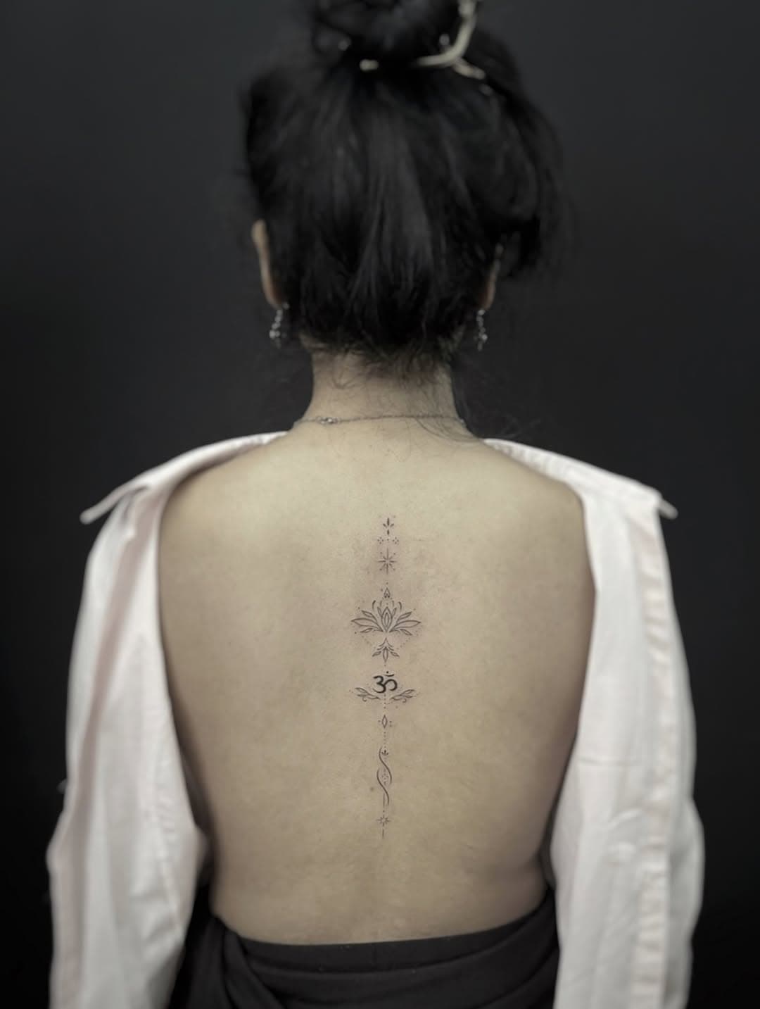 Spine ornamentation with sacred symbols