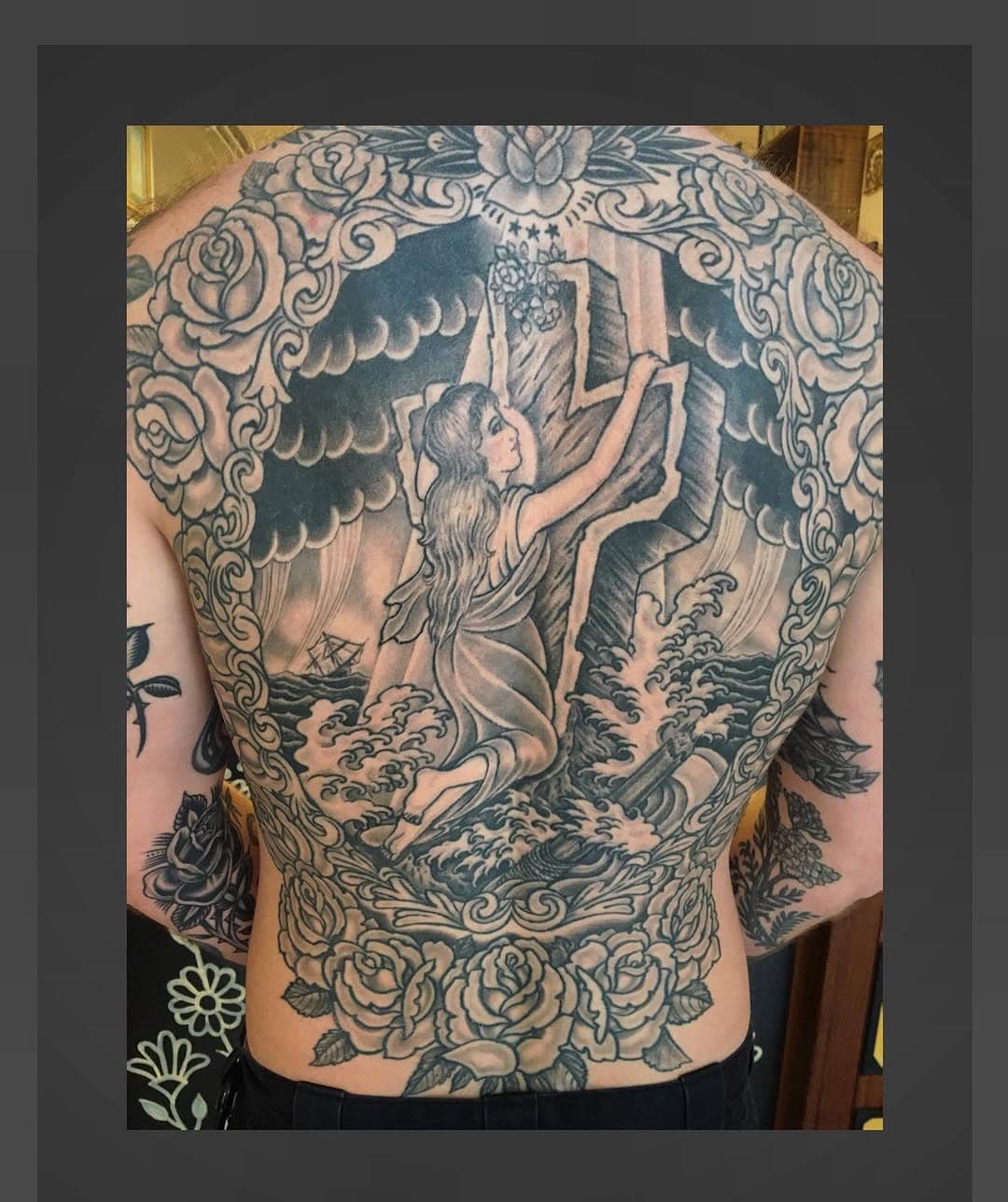 Woman clinging to cross in stormy sea