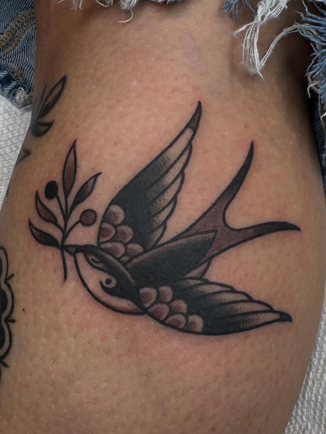 Flying swallow with berry branch