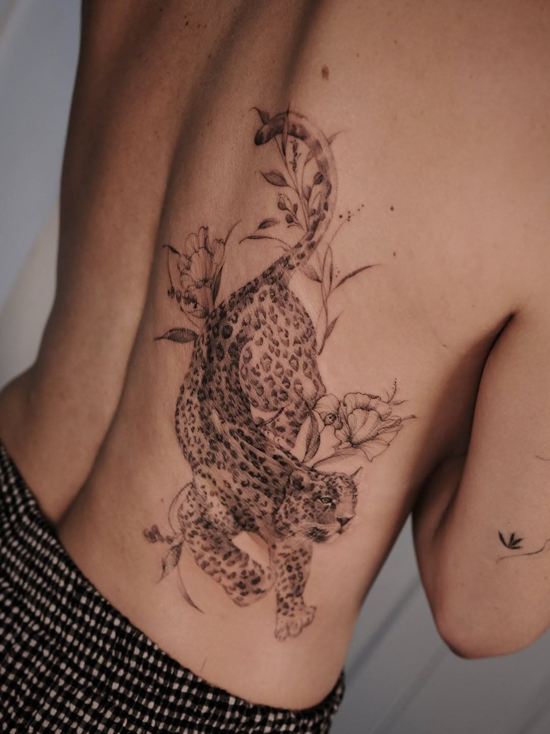 Leopard and botanical arrangement