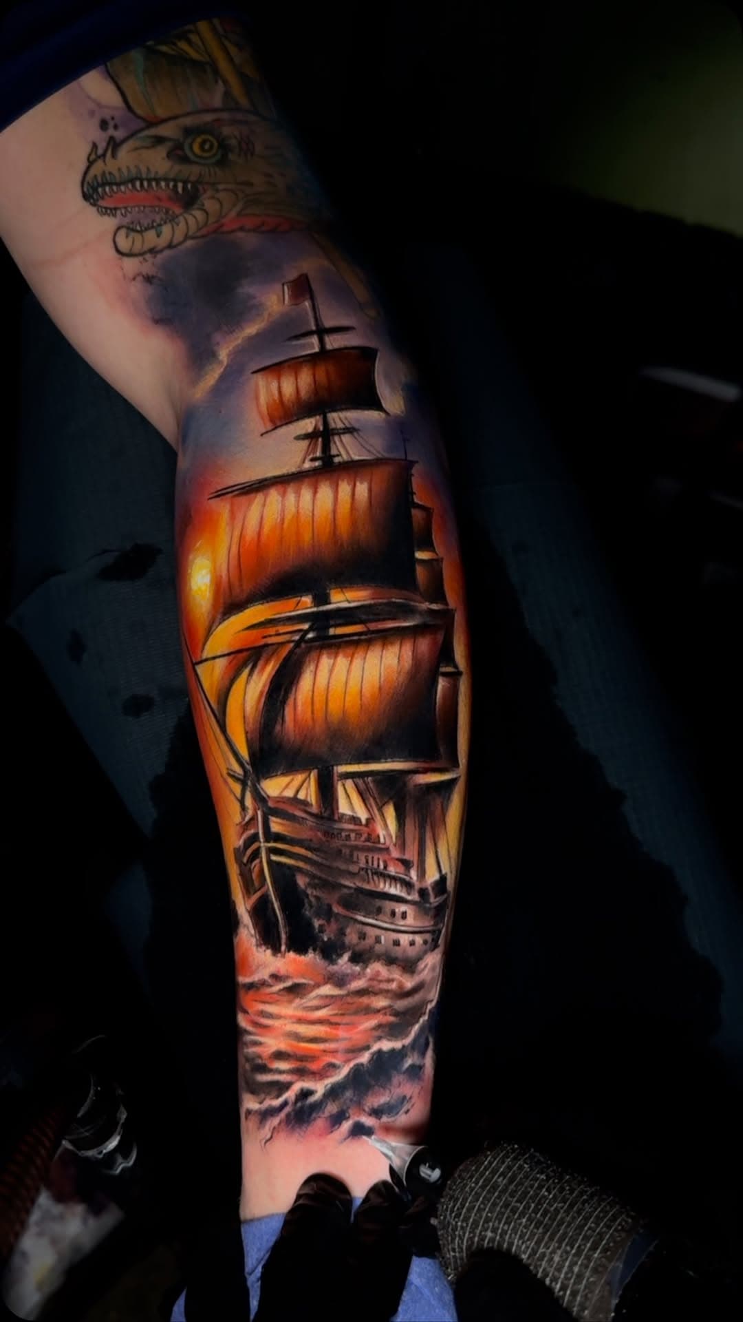 Tall ship at sea with a dinosaur