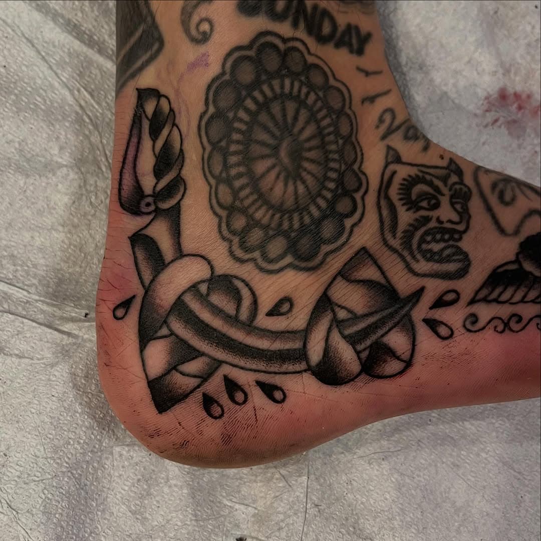 Candle, dagger, and demon face on foot