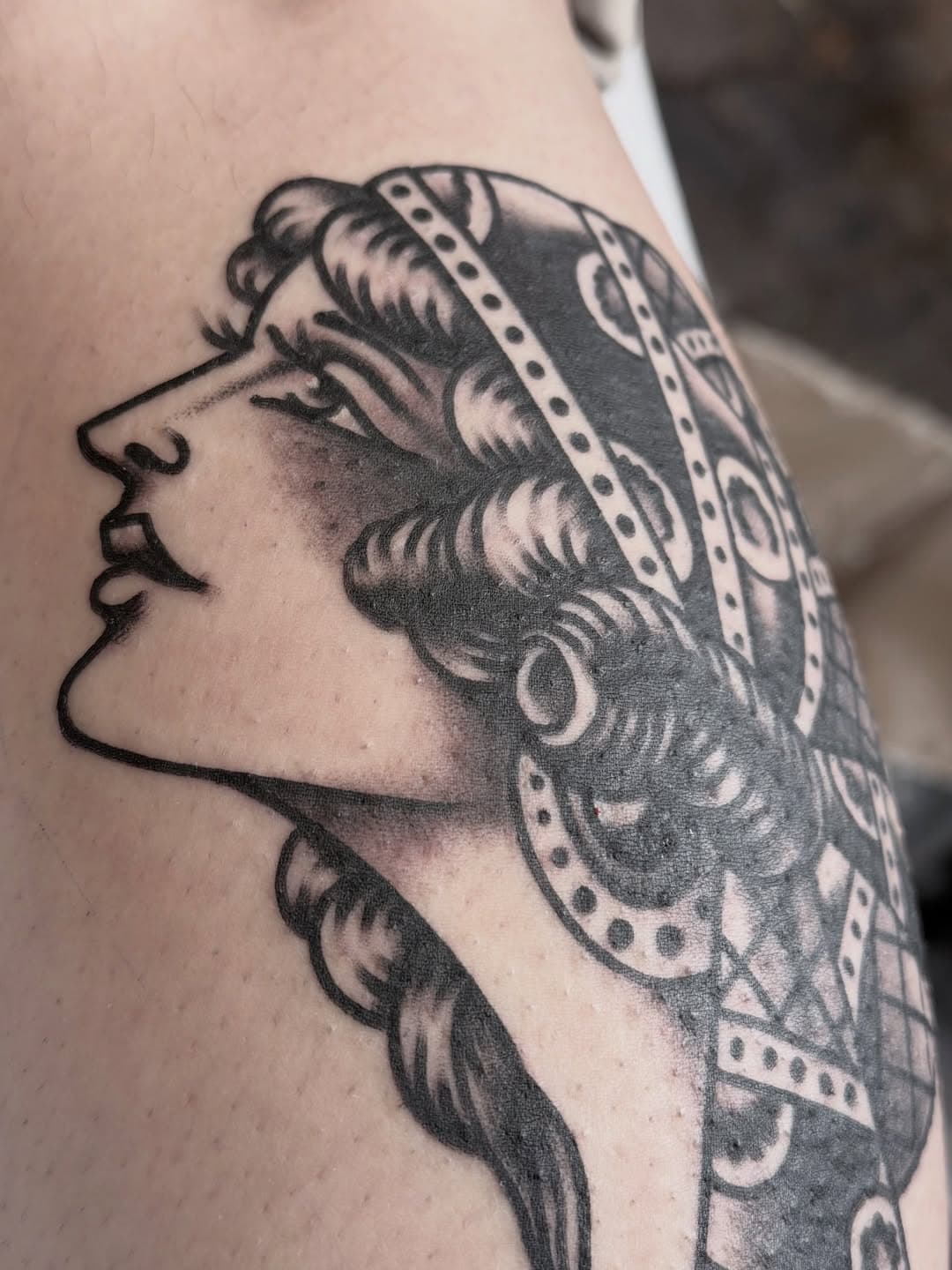 Profile of a woman with patterned head covering