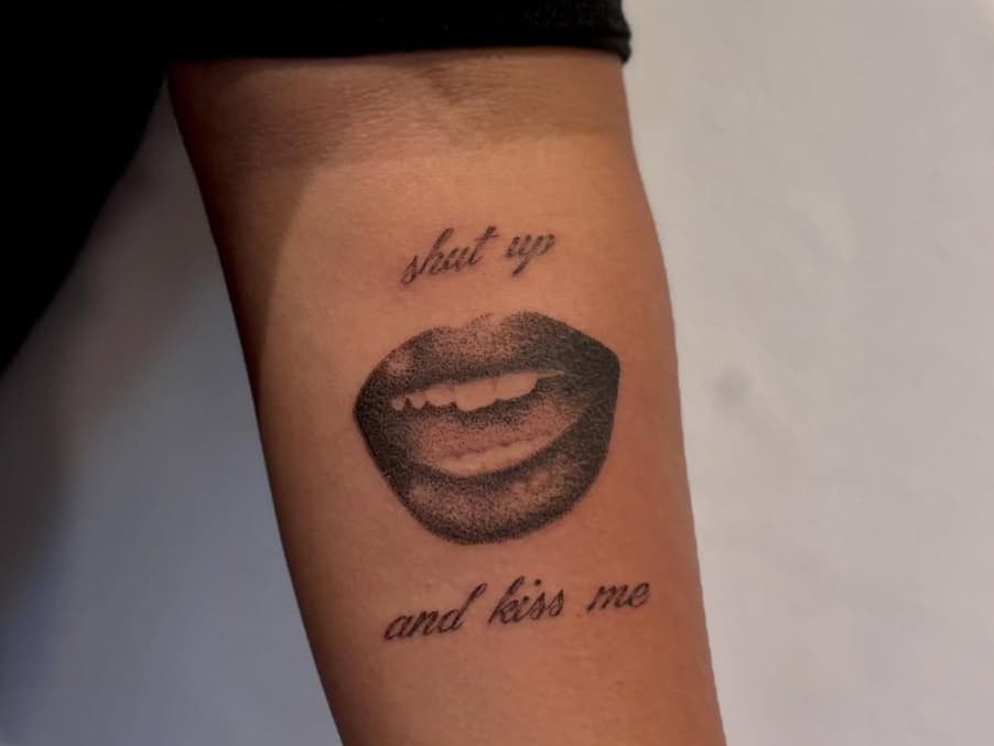 Lips and script lettering on arm