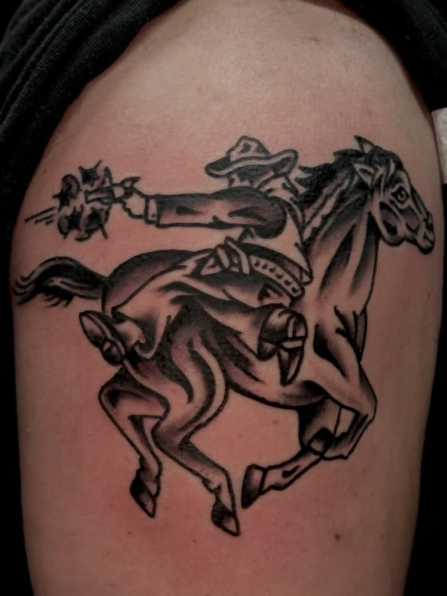 Riding cowboy with smoking pistol