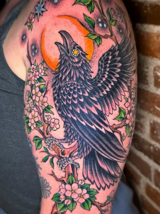 Raven perched on flowering branch under moon and stars