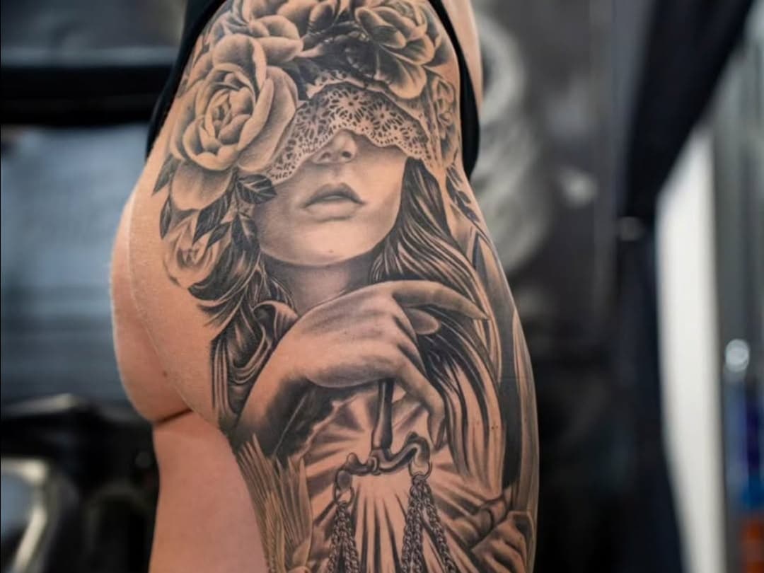 Blindfolded woman with scales and roses